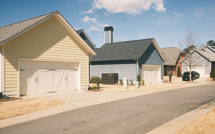 Driveways meeting the street in front of garages on a residential block